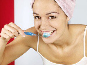 Young woman brushing teeth