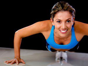 Woman smiling while doing a push up