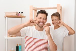 Father and son flossing together