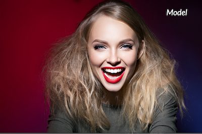 A woman showing off her white teeth after receiving Zoom! Teeth Whitening.