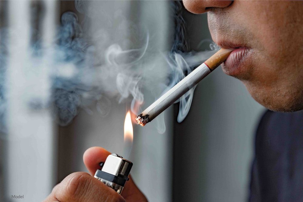 Young man smoking a cigarette.