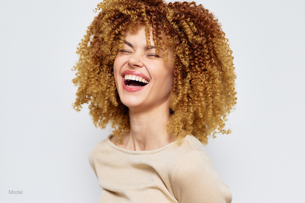 Young woman with curly hair smiling