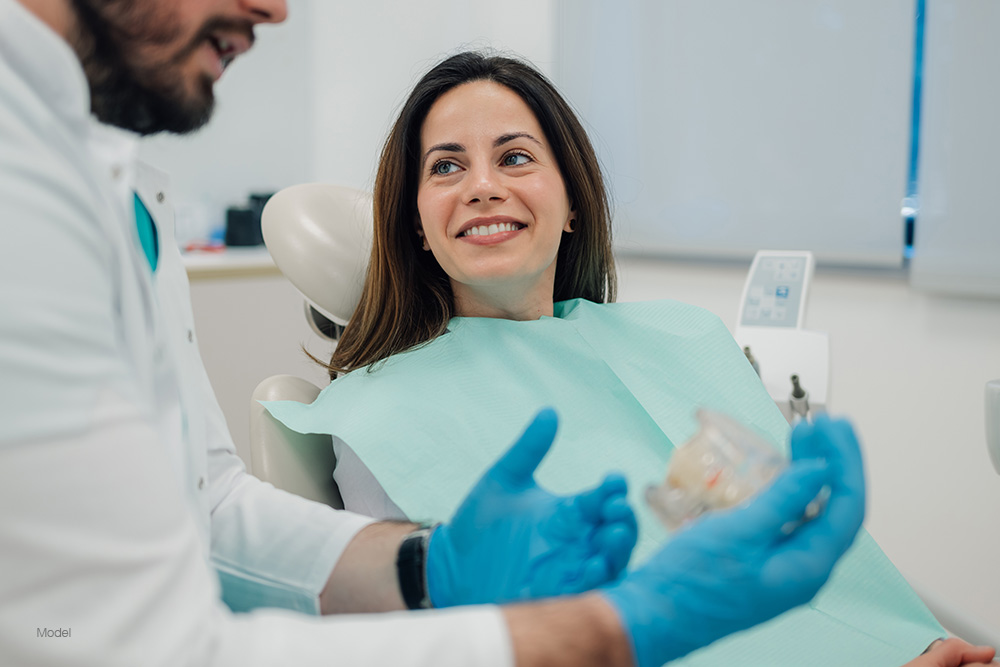 Woman at the dentist talking with the doctor