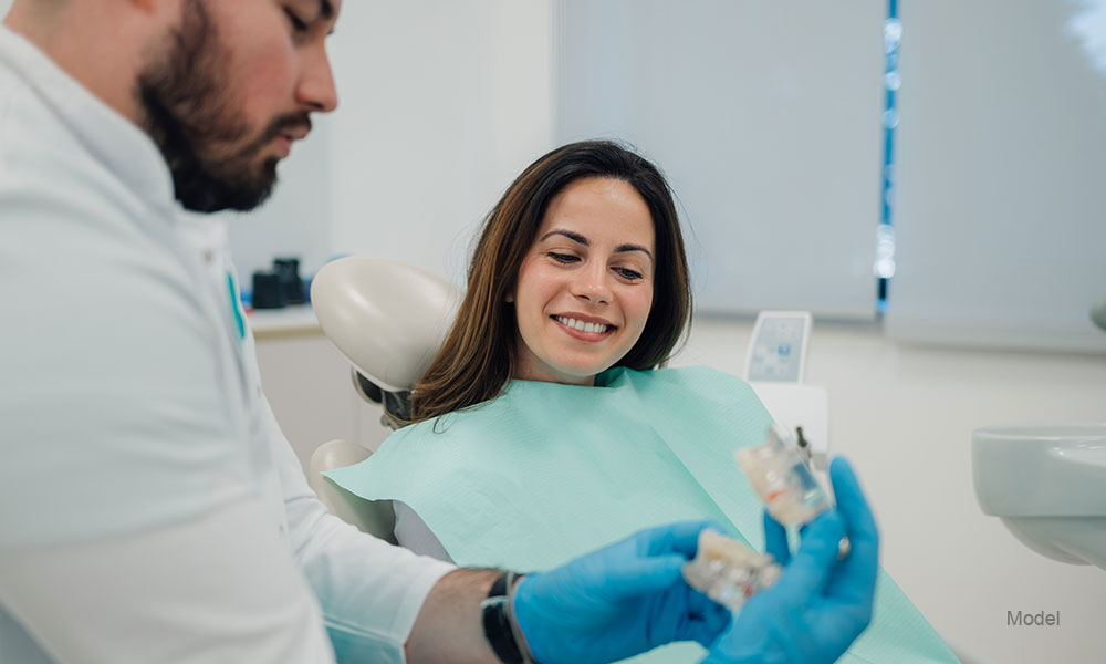 Doctor showing patient dental implants